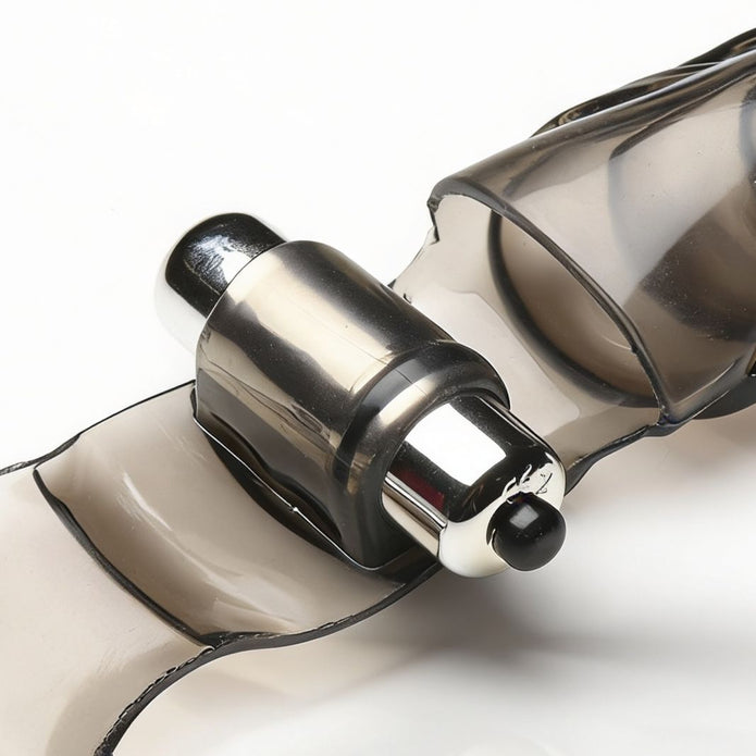 Close-up view of the silver bullet vibrator mounted within the translucent finger glove, highlighting the vibration unit and flexible sleeve.