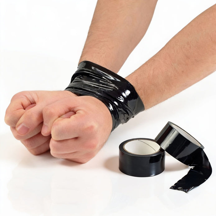 Black bondage tape wrapped around wrists to demonstrate self-adhesive restraint use, with two rolls of tape displayed beside the bound wrists.
