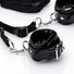 Detailed view of the restraint kit's adjustable strap system, quick-release clips, metal rings, and padded cuff construction