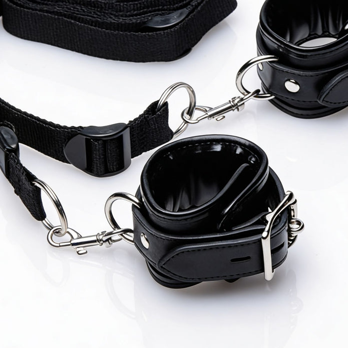 Detailed view of the restraint kit's adjustable strap system, quick-release clips, metal rings, and padded cuff construction