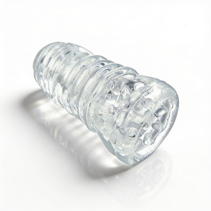 Angled product view of the Palm-Tec LX20 Intense Stroker highlighting the transparent construction, contoured shape, and textured stimulation zones.