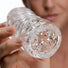Close-up view of the Palm-Tec LX20 Intense Stroker opening, showcasing the transparent material and densely textured entry designed for enhanced stimulation.