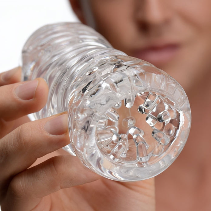 Close-up view of the Palm-Tec LX20 Intense Stroker opening, showcasing the transparent material and densely textured entry designed for enhanced stimulation.