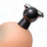 Black vibrating nipple sucker attached to a breast-shaped display, demonstrating how the suction cup fits and stays in place during use.