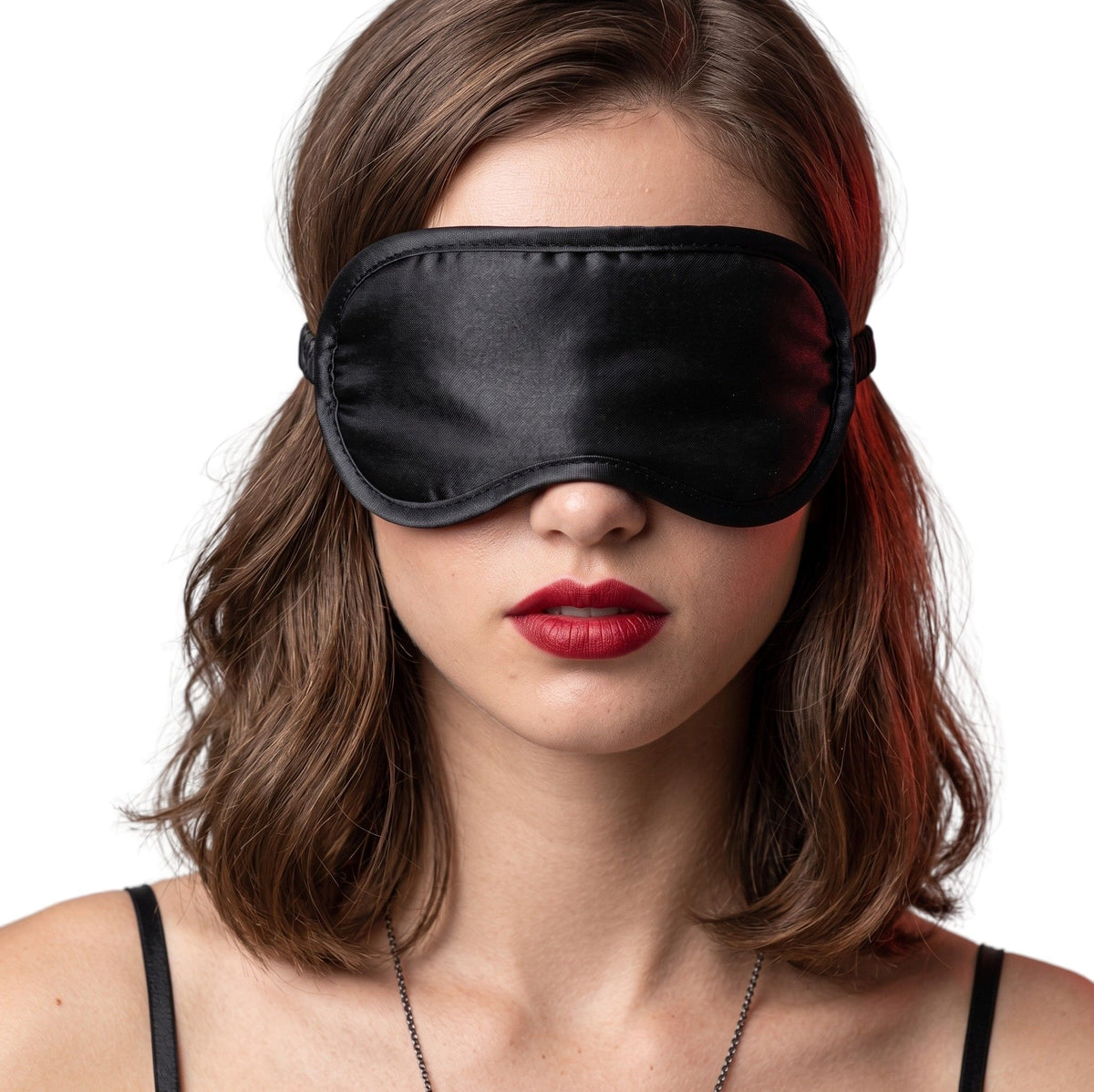 Female model wearing a black satin blindfold with a smooth silky finish and elastic strap, designed to comfortably block light for sensory play and relaxation