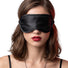 Female model wearing a black satin blindfold with a smooth silky finish and elastic strap, designed to comfortably block light for sensory play and relaxation