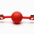 Close-up view of the red silicone ball on the comfort ball gag, highlighting the smooth surface and durable construction