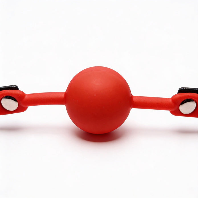 Close-up view of the red silicone ball on the comfort ball gag, highlighting the smooth surface and durable construction