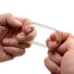 Hands stretching the Super Stretch Universal Cock Ring to demonstrate its highly elastic material, durability, and adaptable fit.