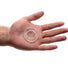Super Stretch Universal Cock Ring displayed in an open palm, highlighting its compact size, clear appearance, and comfortable flexible design.