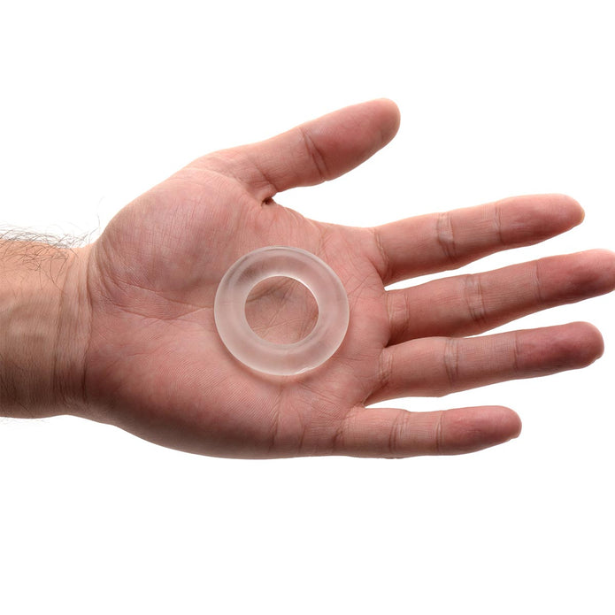 Super Stretch Universal Cock Ring displayed in an open palm, highlighting its compact size, clear appearance, and comfortable flexible design.
